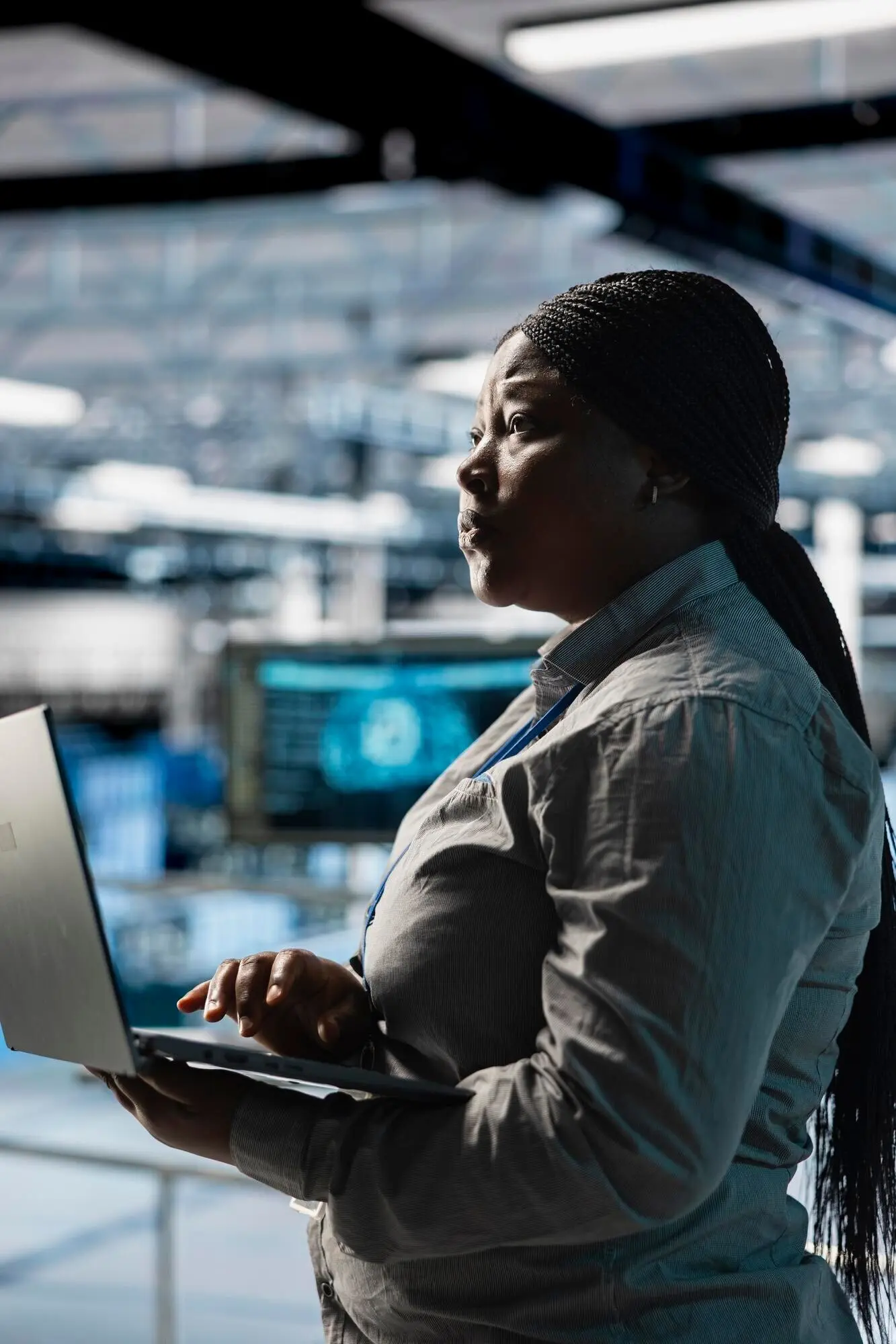 Eine Frau in einer Serverfarm automatisiert mit einem Laptop die Systemdiagnostik mithilfe von Vorhersagen des maschinellen Lernens.